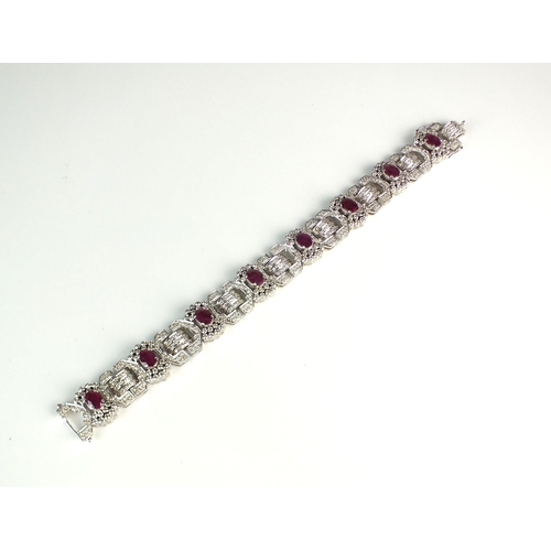 106 - An Art Deco style ruby and diamond bracelet, designed as eight stylised geometric bow links set with... 