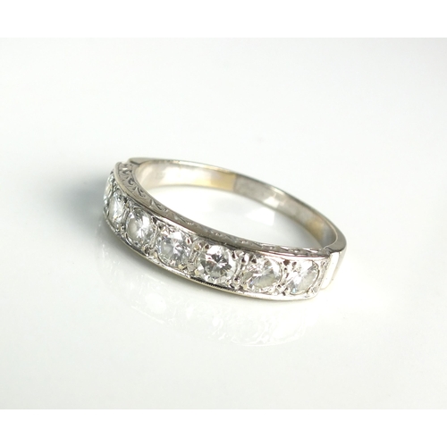 109 - A seven stone diamond half eternity ring, the seven brilliant cut diamonds claw set in white metal t... 