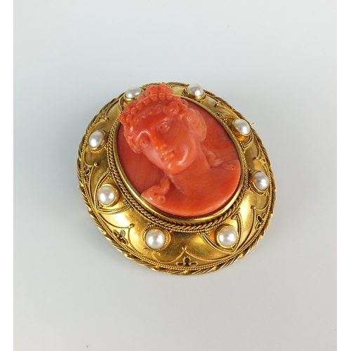 111 - A 19th century carved coral cameo brooch, designed as a central oval carved coral cameo depicting a ... 