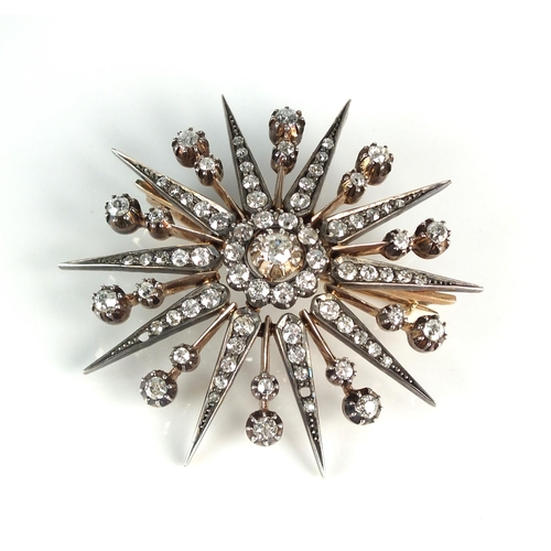 115 - A Victorian diamond star burst brooch pendant, designed as a central old cut diamond claw set within... 