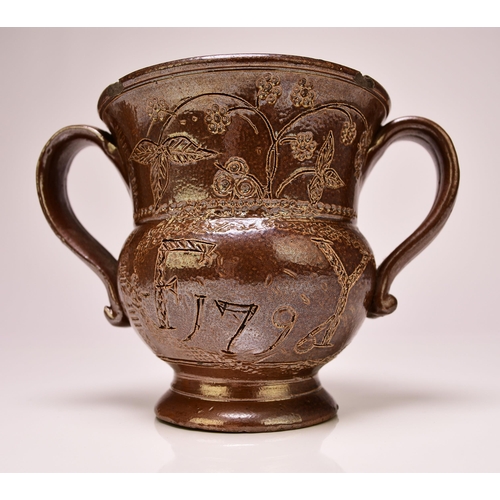 134 - A Belper (Derbyshire) salt-glazed loving cup, inscribed 'F Y' and dated 1796, of twin handled form, ... 