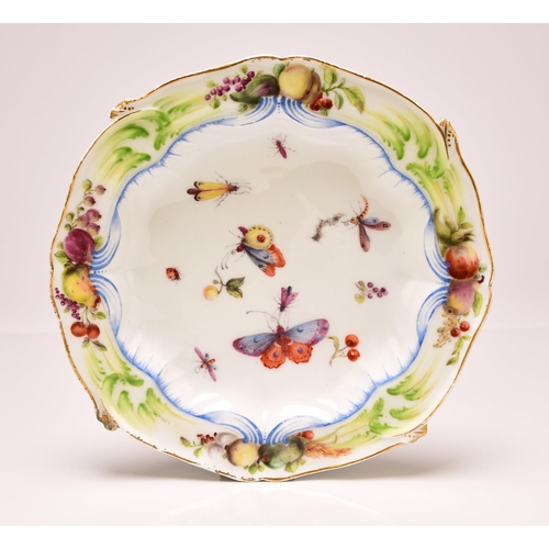 135 - A Chelsea porcelain shaped circular plate, circa 1755, painted with scattered fruit and winged insec... 