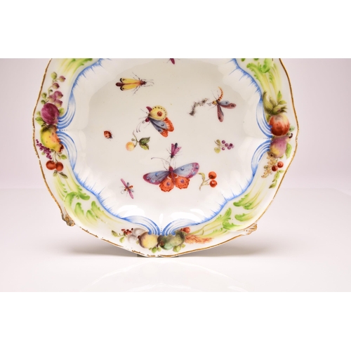 135 - A Chelsea porcelain shaped circular plate, circa 1755, painted with scattered fruit and winged insec... 