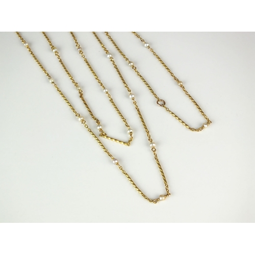 14 - A yellow metal seed pearl set chain, the yellow metal wrythen links set throughout with single seed ... 