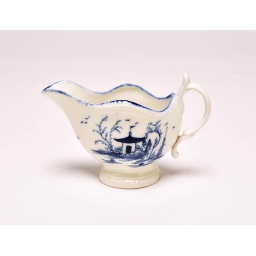 150 - A Caughley cream boat circa 1777-85, of 'gadroon' shape, painted in underglaze blue with the 'Rock H... 