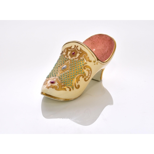 161 - A Coalport 'jewelled' slipper, late 19th/early 20th century the heeled slipper with a pale yellow ex... 