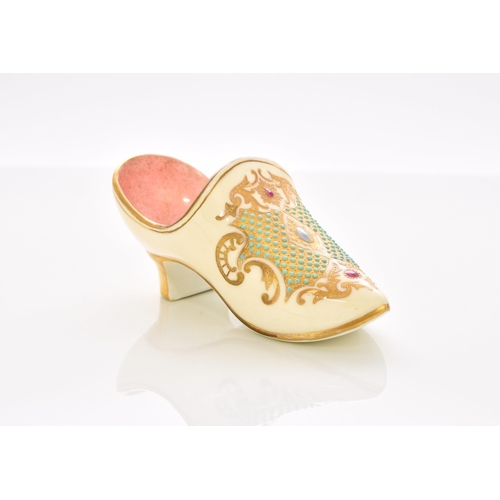 161 - A Coalport 'jewelled' slipper, late 19th/early 20th century the heeled slipper with a pale yellow ex... 