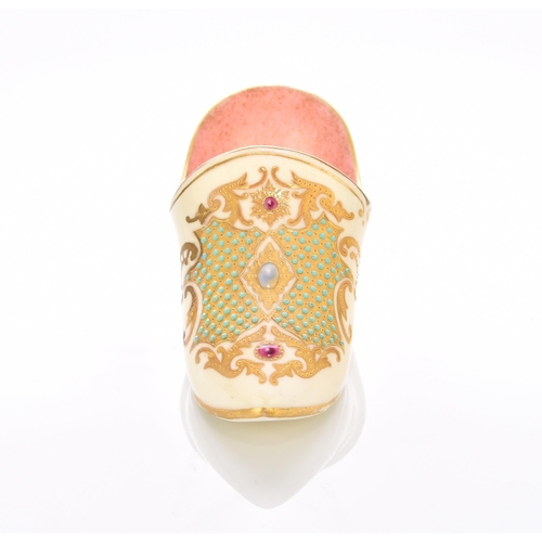 161 - A Coalport 'jewelled' slipper, late 19th/early 20th century the heeled slipper with a pale yellow ex... 