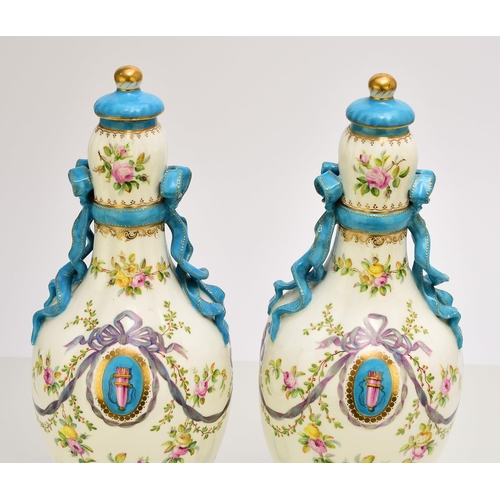 177 - A pair of Coalport ribbon vases and covers, circa 1860 the lobed ovoid forms tied at the bulbous nec... 