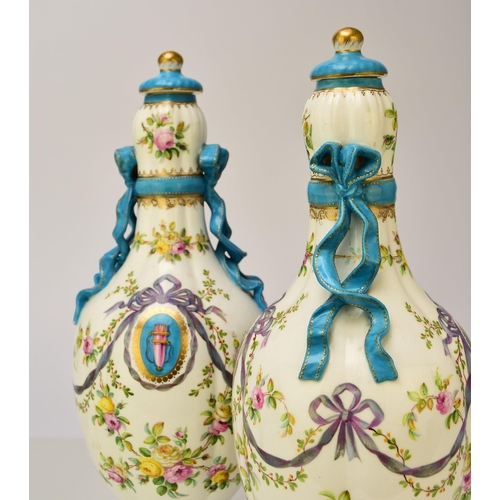 177 - A pair of Coalport ribbon vases and covers, circa 1860 the lobed ovoid forms tied at the bulbous nec... 