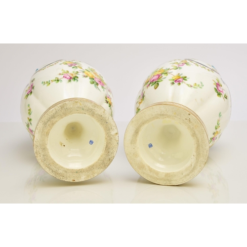 177 - A pair of Coalport ribbon vases and covers, circa 1860 the lobed ovoid forms tied at the bulbous nec... 