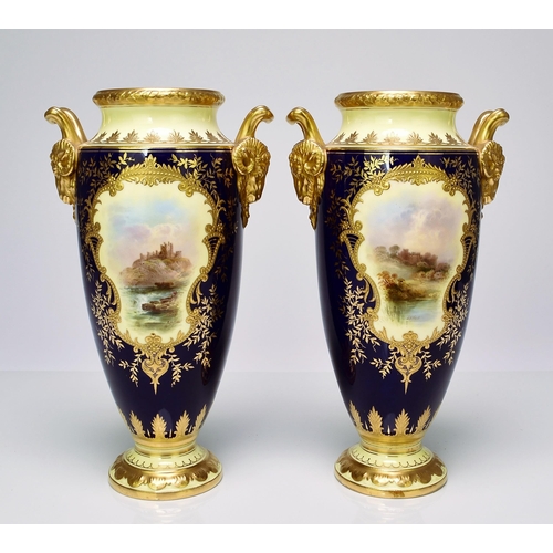 182 - A pair of Coalport vases, circa 1900-10 of tall, ovoid form, with twin rams head handles, the cobalt... 