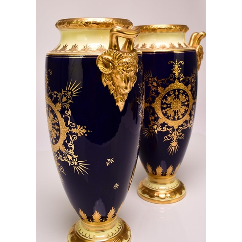 182 - A pair of Coalport vases, circa 1900-10 of tall, ovoid form, with twin rams head handles, the cobalt... 