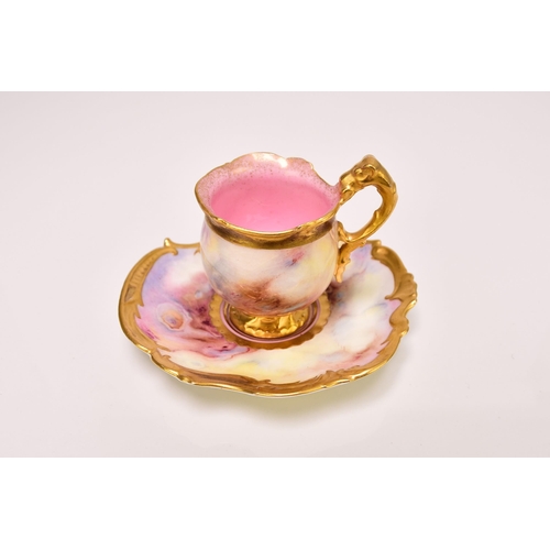 194 - A Coalport cabinet cup and saucer, circa 1910-15 the pink and yellow agate or faux marble ground wit... 