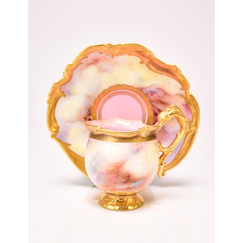 194 - A Coalport cabinet cup and saucer, circa 1910-15 the pink and yellow agate or faux marble ground wit... 