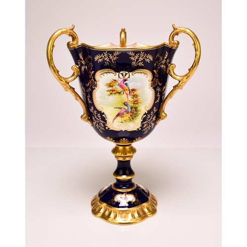 197 - A Coalport trophy vase painted with vignettes of exotic birds, circa 1900-1910 of three handled form... 