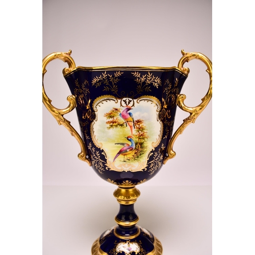 197 - A Coalport trophy vase painted with vignettes of exotic birds, circa 1900-1910 of three handled form... 