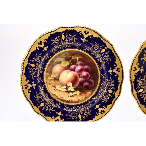 198 - A pair of Coalport scalloped cabinet plates, circa 1920, painted with still lives of fruit by Freder... 