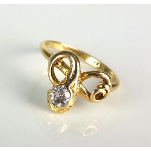 20 - An early 20th century diamond set snake ring, designed as a yellow metal stylised entwined snake wit... 