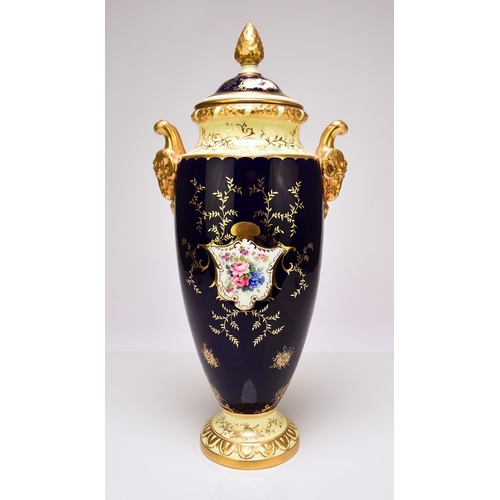 207 - A large Coalport twin-handled landscape vase and cover, circa 1910 with rams head handles, painted w... 