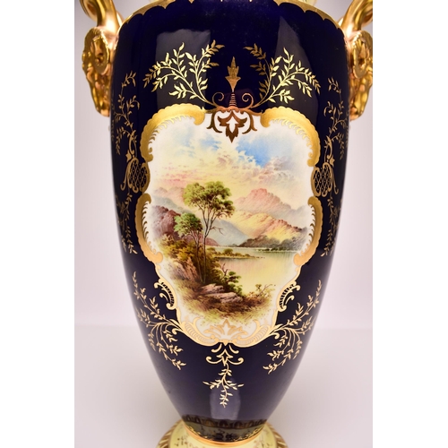 207 - A large Coalport twin-handled landscape vase and cover, circa 1910 with rams head handles, painted w... 