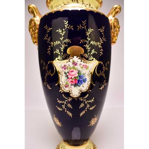 207 - A large Coalport twin-handled landscape vase and cover, circa 1910 with rams head handles, painted w... 