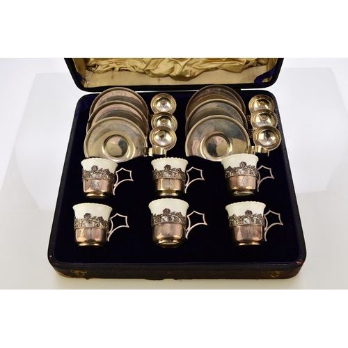 215 - A cased silver-mounted Coalport coffee service, with unusual silver saucers and teaspoon holders, ha... 