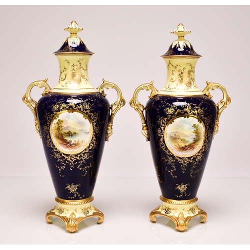 231 - A pair of Coalport vases and covers, circa 1891-1919 of twin-handled form, the dark blue ground pain... 