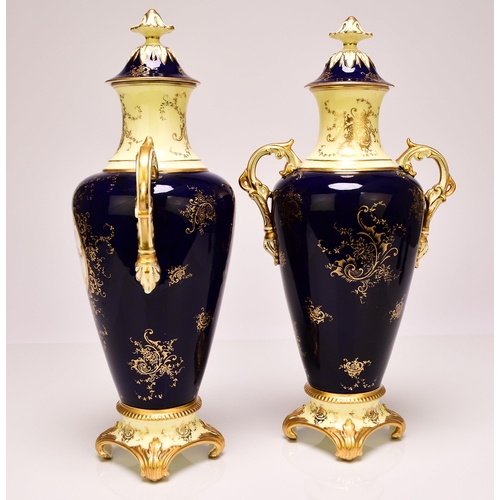 231 - A pair of Coalport vases and covers, circa 1891-1919 of twin-handled form, the dark blue ground pain... 