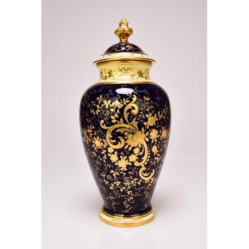 233 - A Coalport baluster vase and cover, circa 1920s the deep cobalt and lavish gilt ground painted with ... 