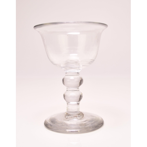 244 - A small English sweetmeat glass, circa 1750, the bell bowl with an averted rim, set above a clear do... 