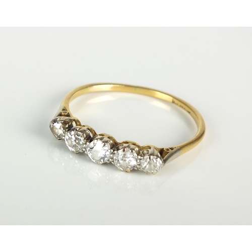 30 - A graduated five stone diamond ring, the five old cut diamonds claw set in white metal to yellow met... 