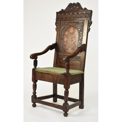 339 - A 17th century and later marquetry wainscot chair The carved back with scroll top rail and carved ar... 