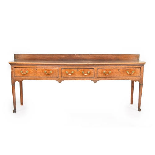 340 - A George III oak dresser base The rectangular 3-plank top with a ledge back, above 3 frieze drawers ... 