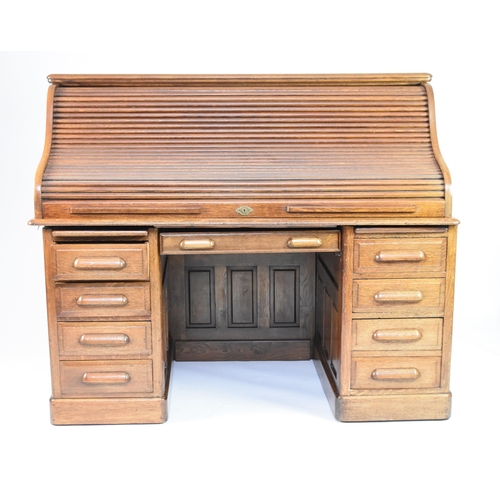 344 - A 20th century oak roll-top pedestal desk The top with tambour shutter enclosing multiple drawers an... 