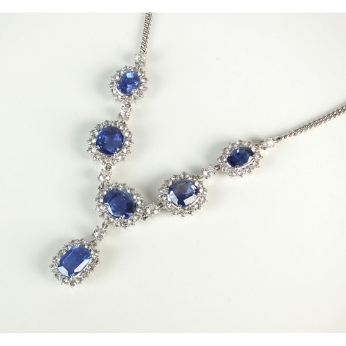 35 - A blue sapphire cluster necklace, designed as five oval mixed cut sapphires claw set within a border... 