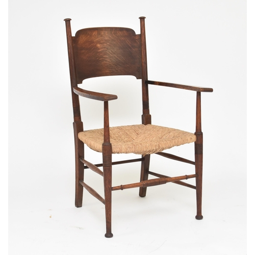 351 - An Arts and Crafts style rush-seated oak armchair After a design by E.G. Punnett and likely made by ... 