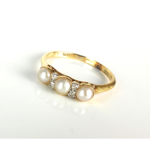 58 - An early 20th century untested pearl and diamond ring, designed as three split pearls interspersed w... 