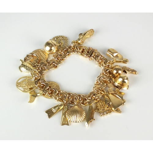 63 - A yellow metal double scroll link bracelet, with attached yellow metal and gold charms, to include; ... 