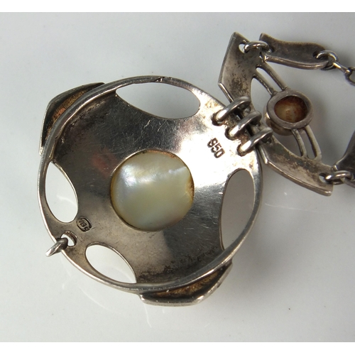 72 - A Murrle Bennett Arts & Crafts silver and mother of pearl pendant on chain, designed as a central ci... 