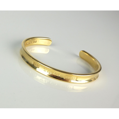 74 - A Tiffany & Co 18ct yellow gold torque bangle, the outer bangle inscribed '750 T & CO 1837', the inn... 