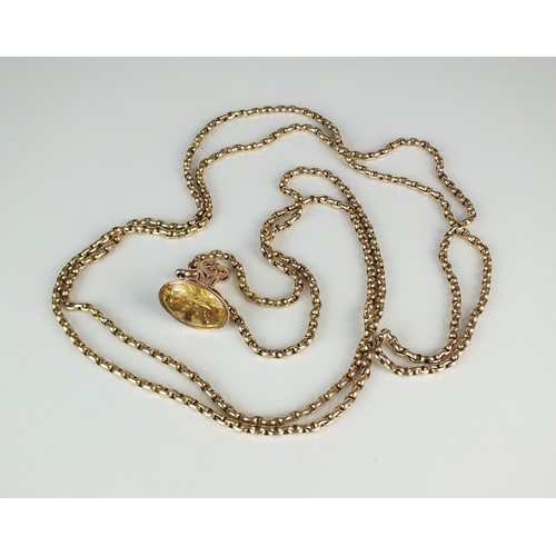 75 - A yellow metal guard chain, with attached swivel, stamped '9c', suspending yellow metal oval faceted... 