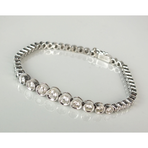 82 - A diamond set line bracelet, the forty-seven graduated brilliant cut diamonds all illusion set in wh... 