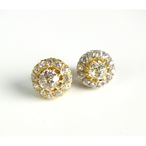 86 - A pair of diamond cluster earrings, each designed as a central old cut diamond claw set in yellow me... 