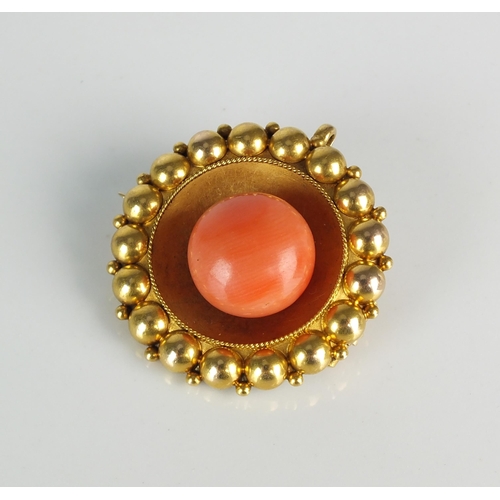 91 - A late 19th century Etruscan revival coral brooch, the central circular coral bead mounted to yellow... 