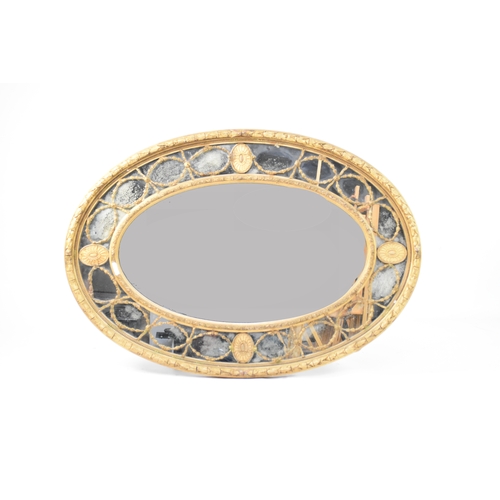 356 - A Regency revival giltwood and gesso oval overmantel mirror, 19th century The concentric oval plates... 