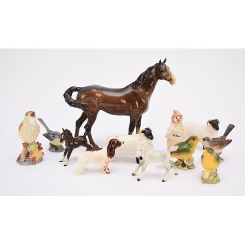 122 - A collection of models of animals, comprising Royal Doulton - Seated Spaniel with Pheasant, HN1028; ... 