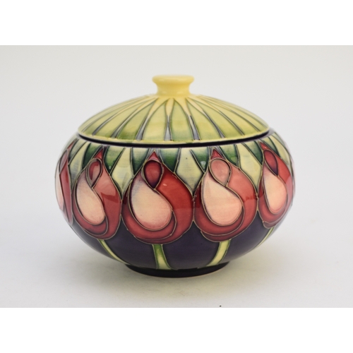 222 - A Moorcroft jar and cover in the 'April Tulip' pattern designed by Emma Bossons, dated 2003, 10cm hi... 