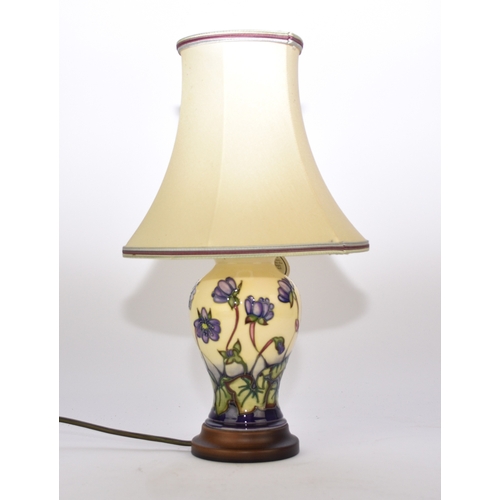 224 - A Moorcroft table lamp in the 'Hepatica' pattern, 18.5cm high including base, with original shade, o... 