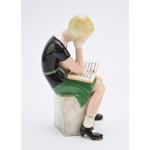 263 - A Goldscheider figure of a girl reading a book modelled by Claire Weiss, no. 6769, painted 'Weiss' t... 